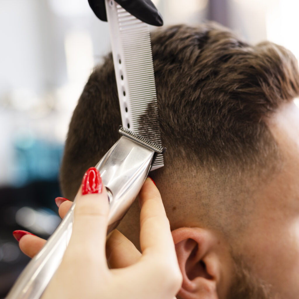 woman cutting her client s hair close up